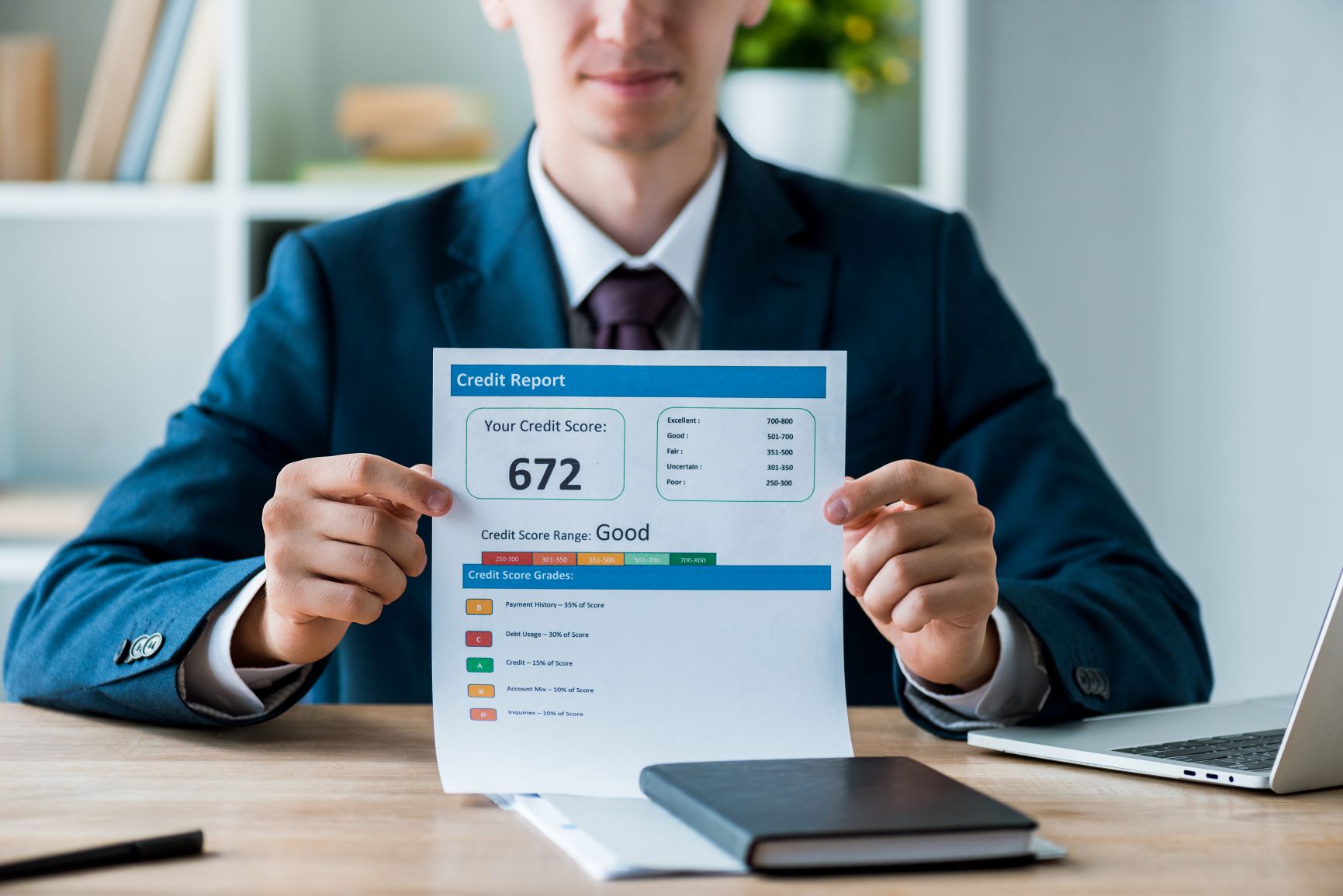 man in suit holding up credit report