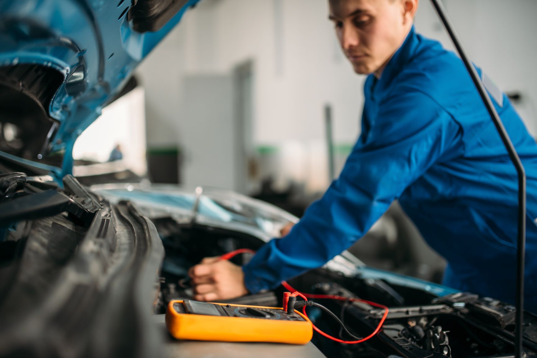 mechanic working on car battery