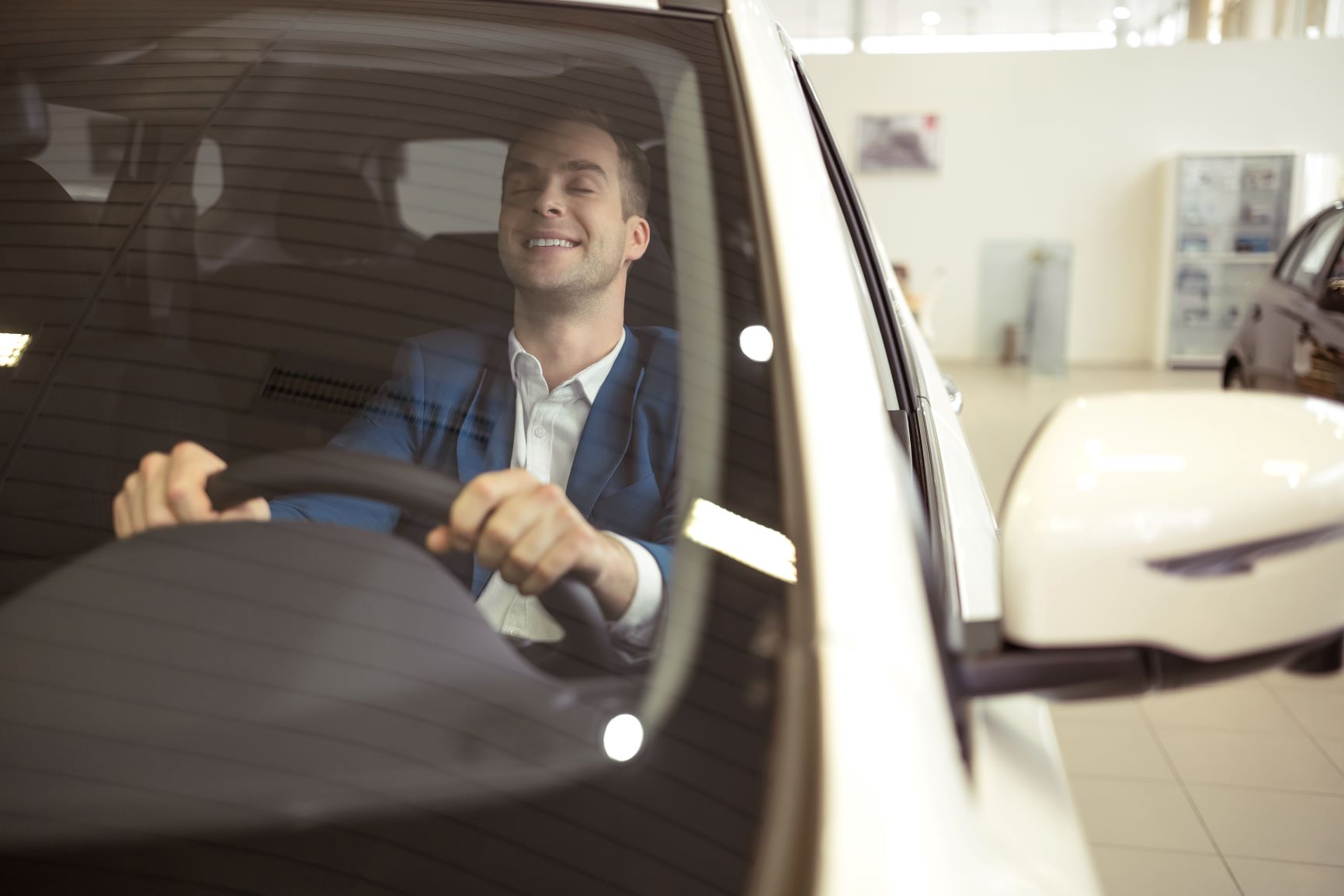 man sitting in driver seat of a car
