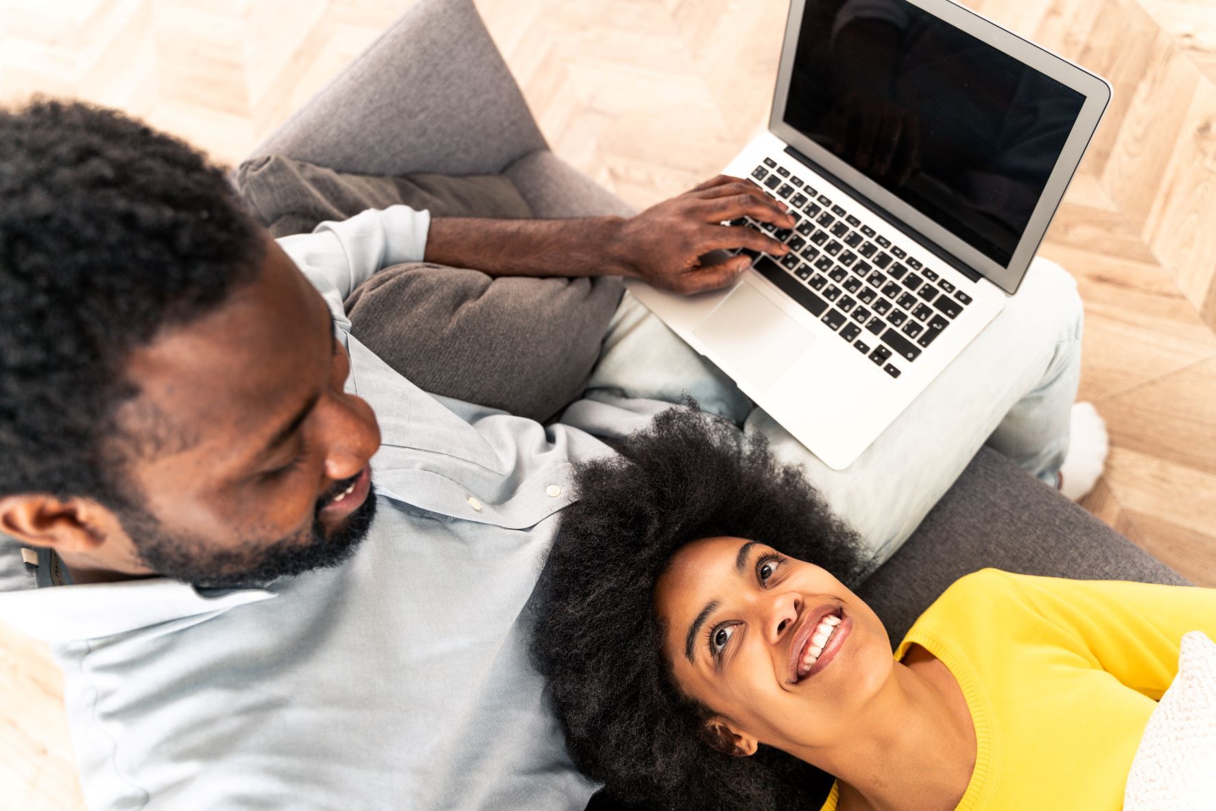Couple on couch with laptop