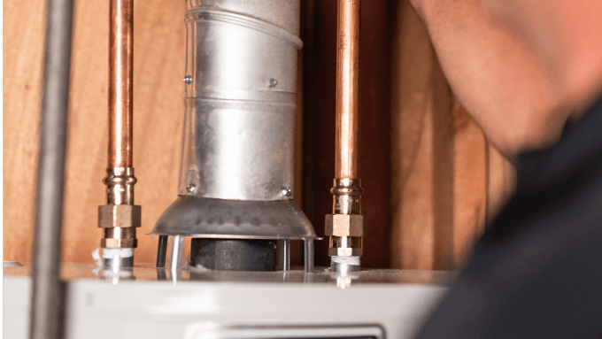 A picture of an atmospheric vent water heater.