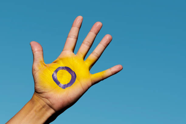 the intersex flag in the palm of the hand intersex stock pictures, royalty-free photos & images
