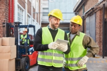 Logistic workers using a tablet