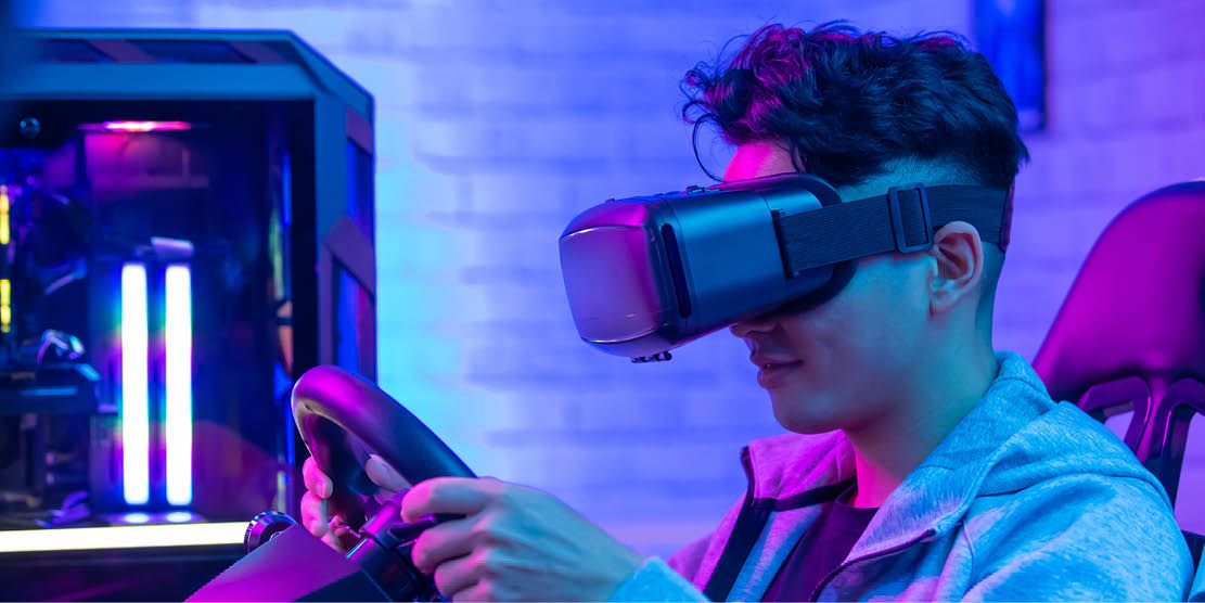 A young man tests a VR driving simulator
