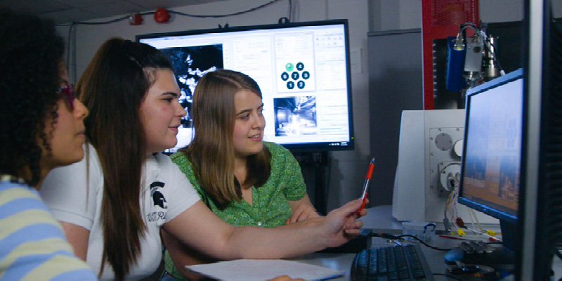 female engineers work collaboratively on computer