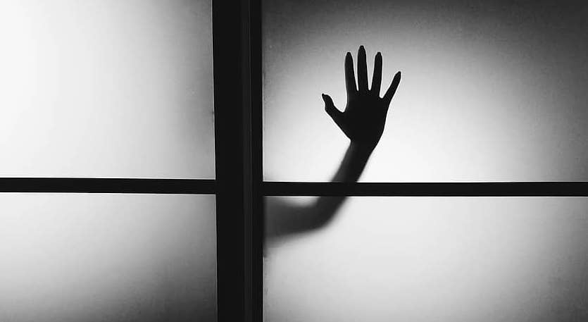 Hand on the window