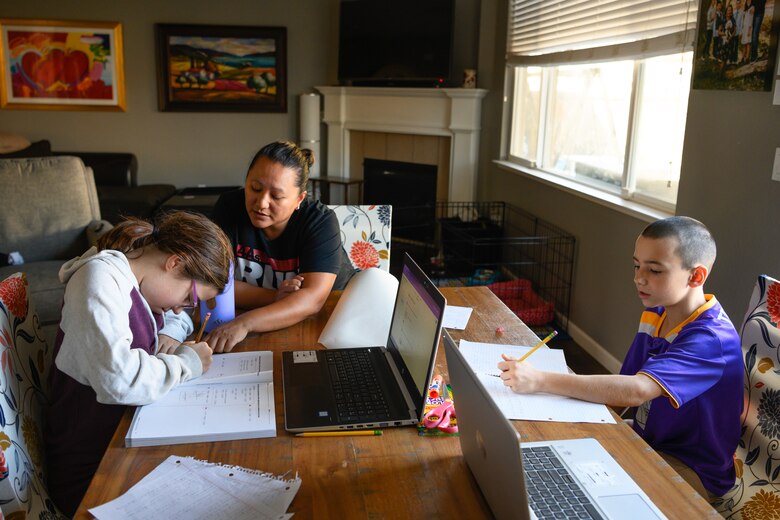 teacher instructing two students