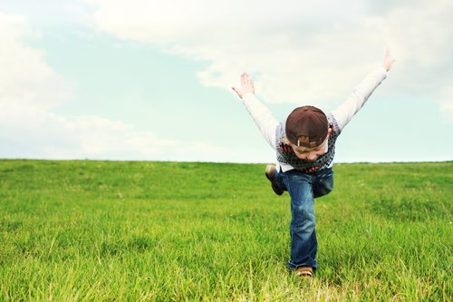 A boy playing in the grass.