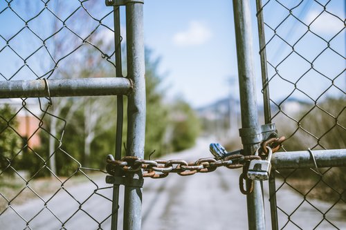 Chain linked fence locked with another chain.