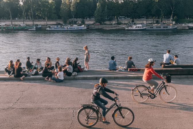 A couple cycling next to a lake for their commute