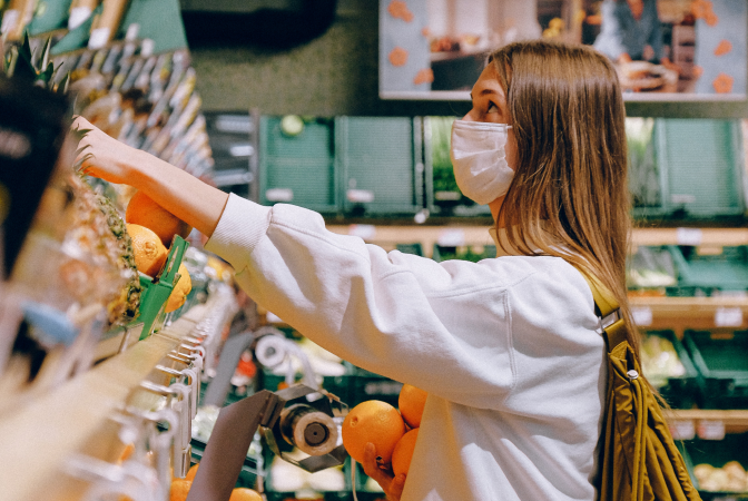 A girl choosing to shop for plant-based groceries