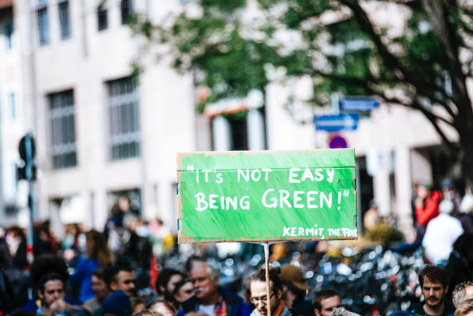Group of climate activists holding a sign