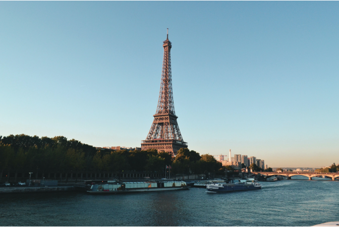The eiffel tower with river in the foreground