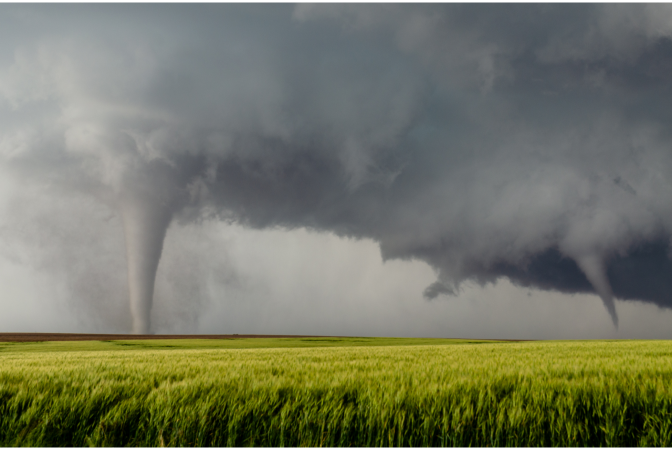 Two tornados over pasture land