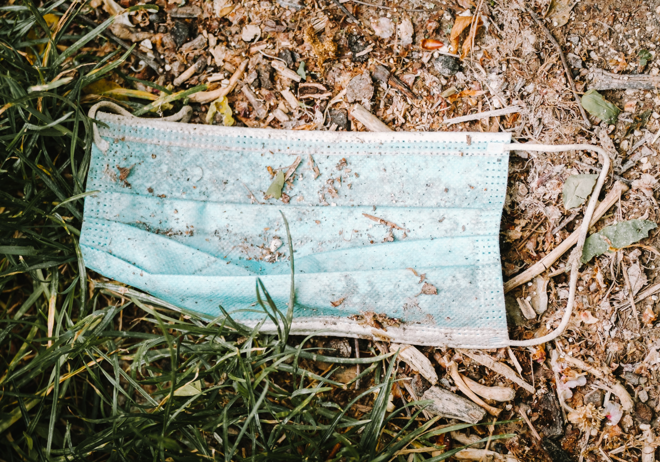 Single-use plastic mask contributing to plastic pollution.