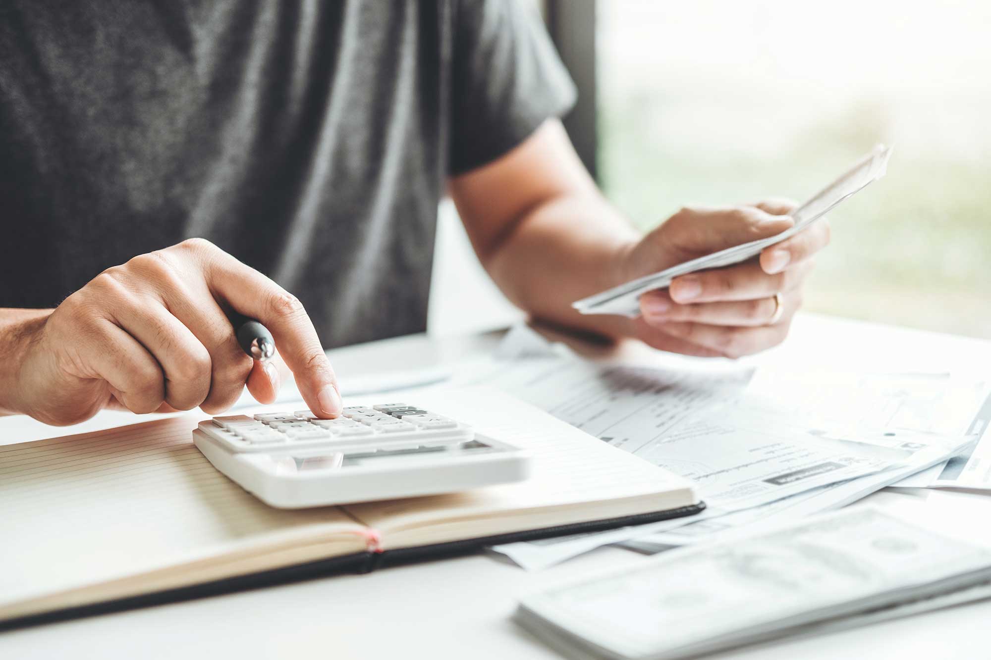 A man using a calculator at a desk