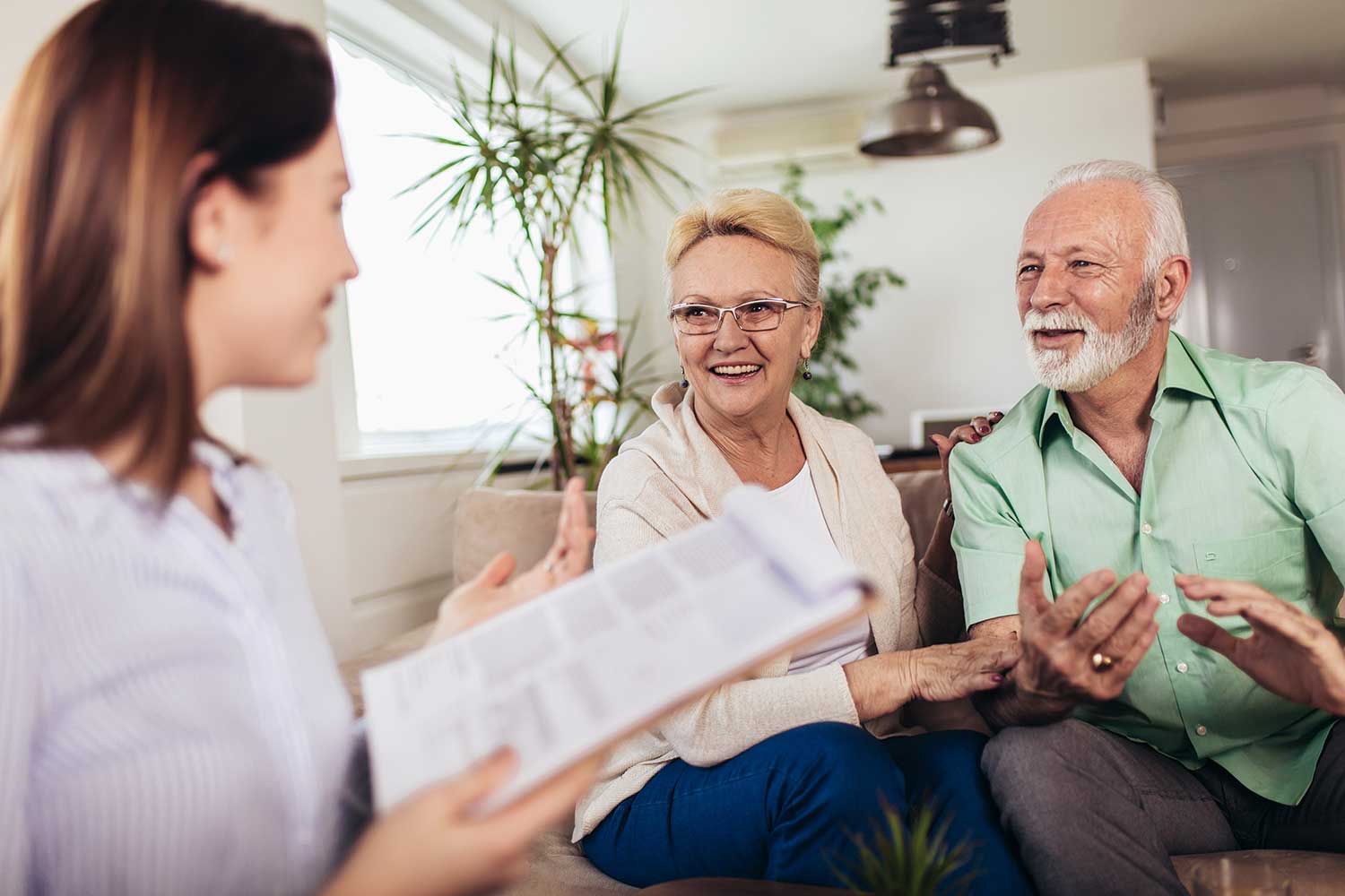 A senior man and woman speaking with an advisor