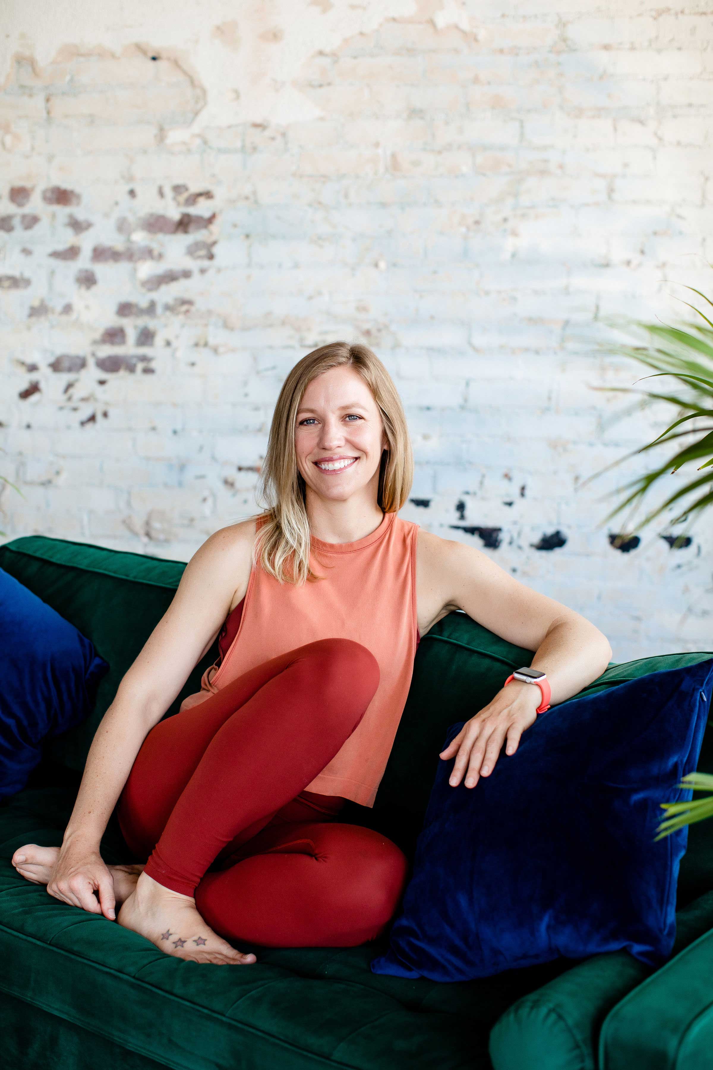 A female yoga teacher sitting on a sofa