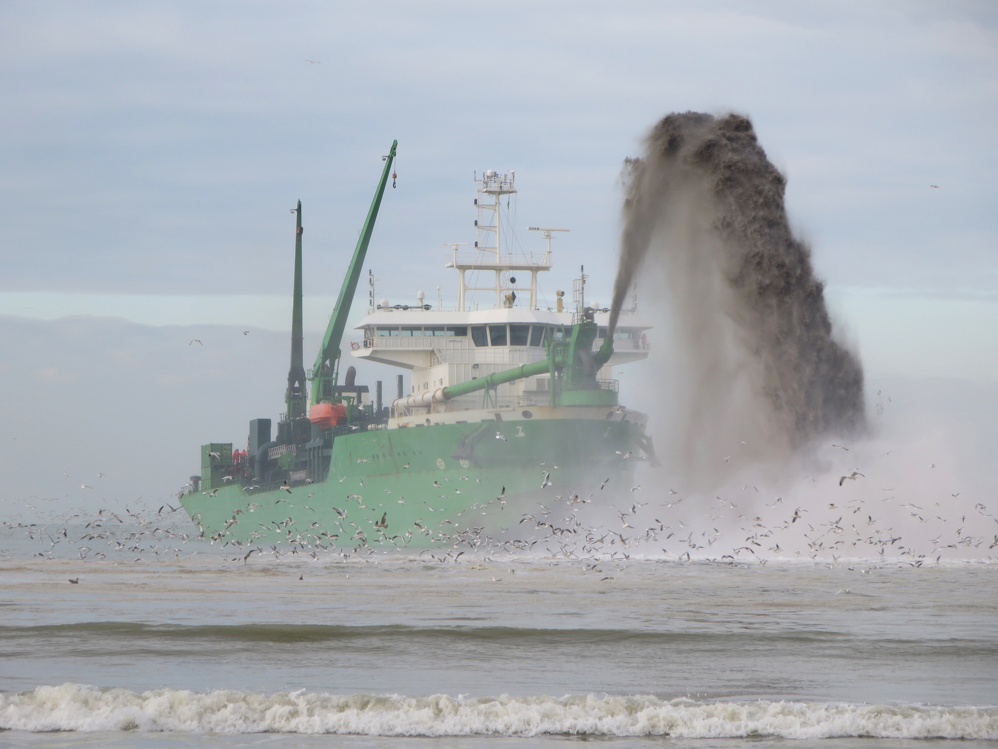 Dredger exavating material from the seabed to increase water depth