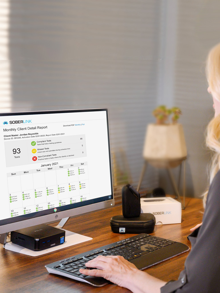 A Woman Checking The Soberlink Client Detail Report