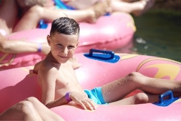 Boy sitting in a float in the Lazy Pearl River