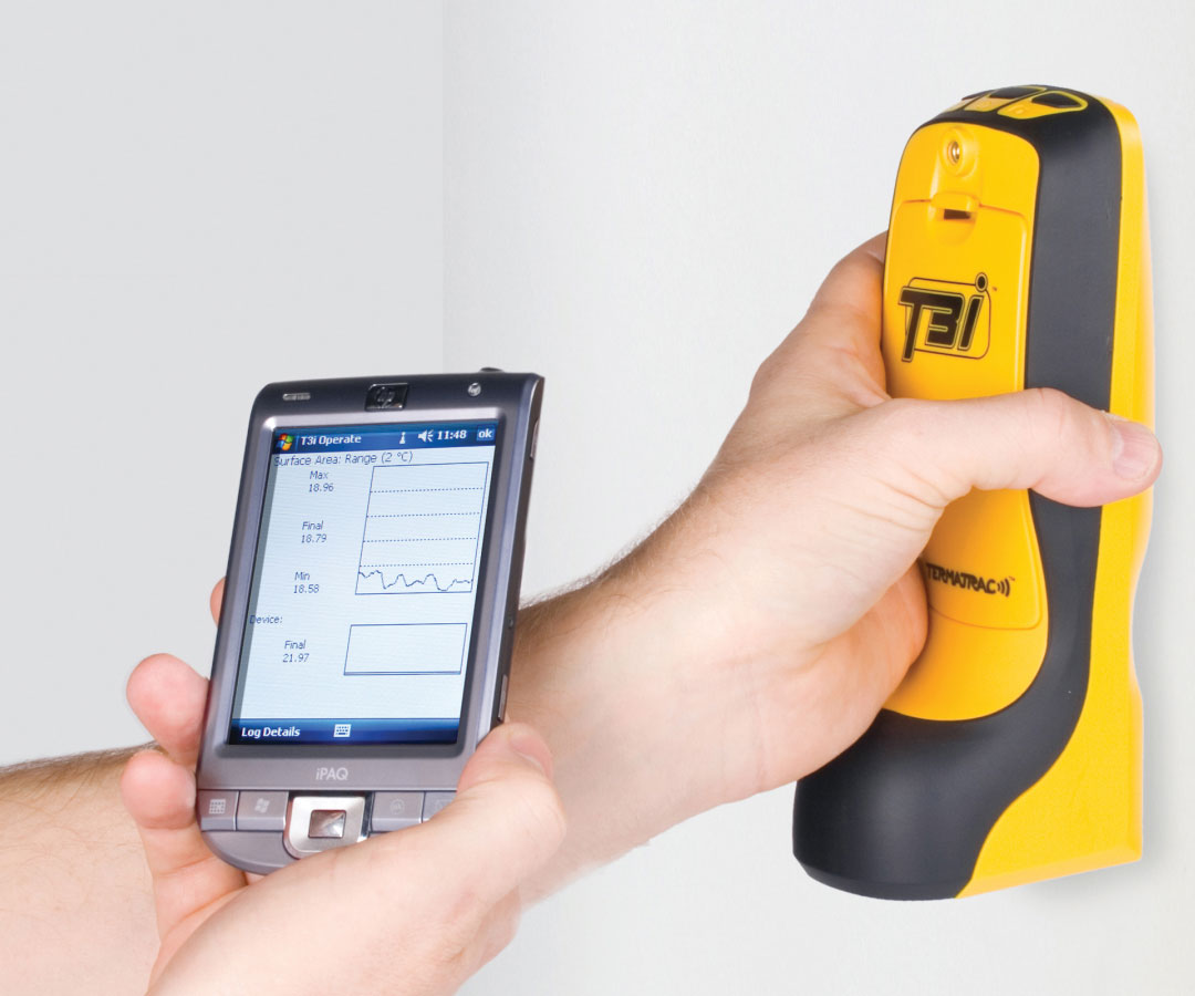 Tim using a Termatrac device on a wall