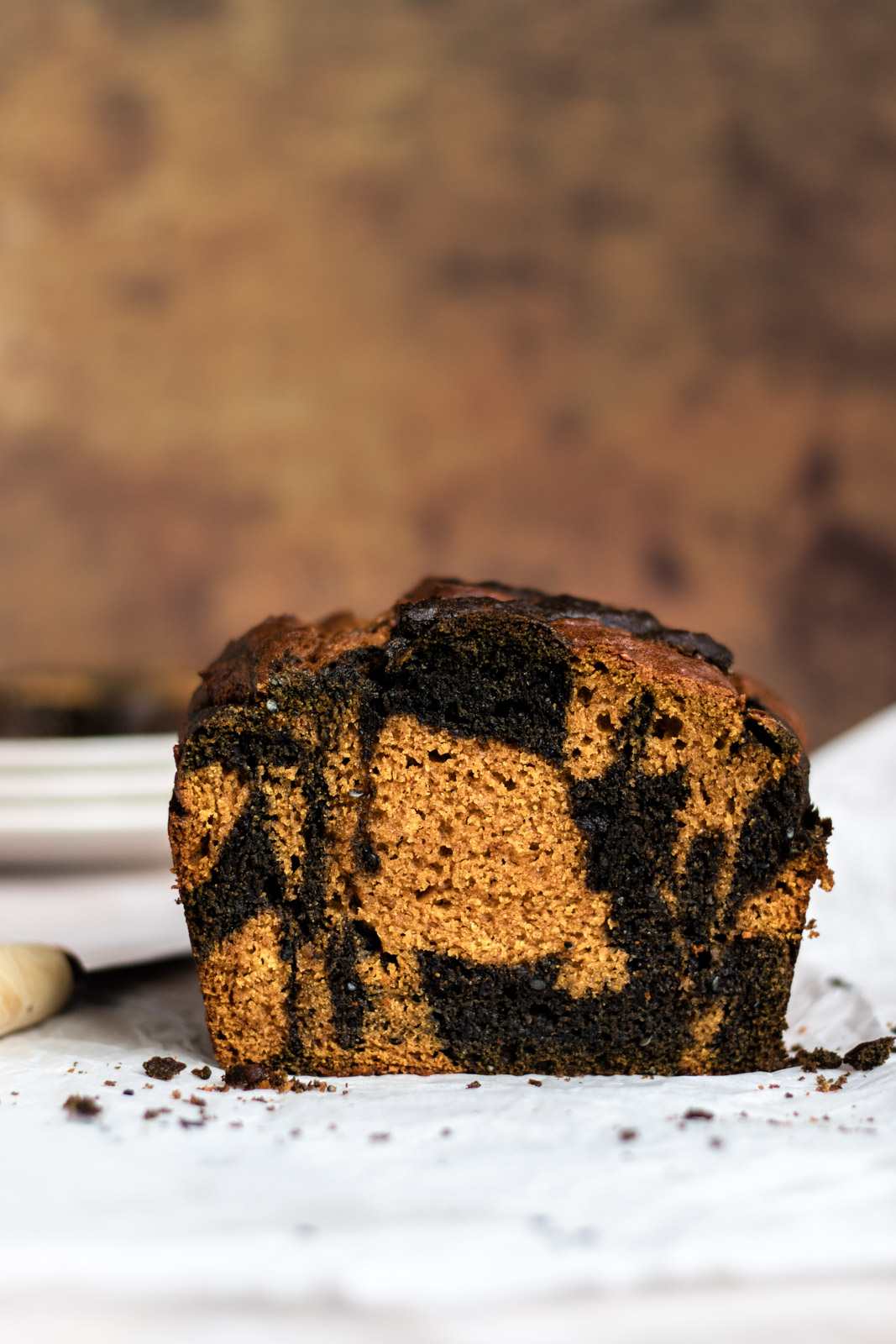 Crumb shot side-view of a loaf of black sesame swirl pumpkin bread