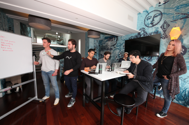 Ben Lee and Neon Roots team collaborating in front of white board