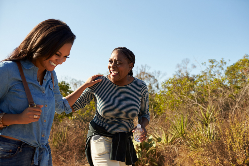 Friends hiking through a field.