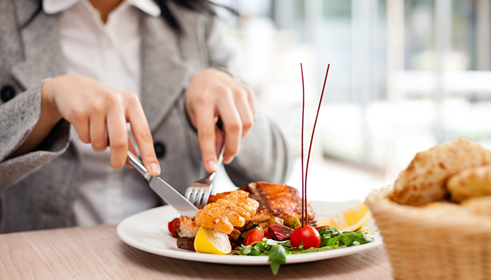 bigstock-woman-eating-at-restaurant-452152301