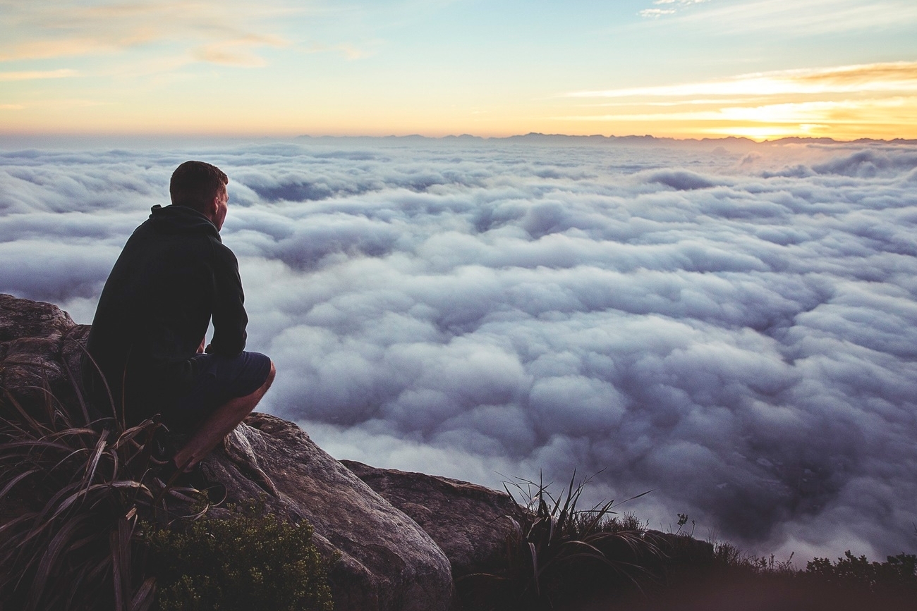 20151208175408-man-top-mountain-clouds-thinking-meditating-peace-relaxation-peak-sunset-horizon