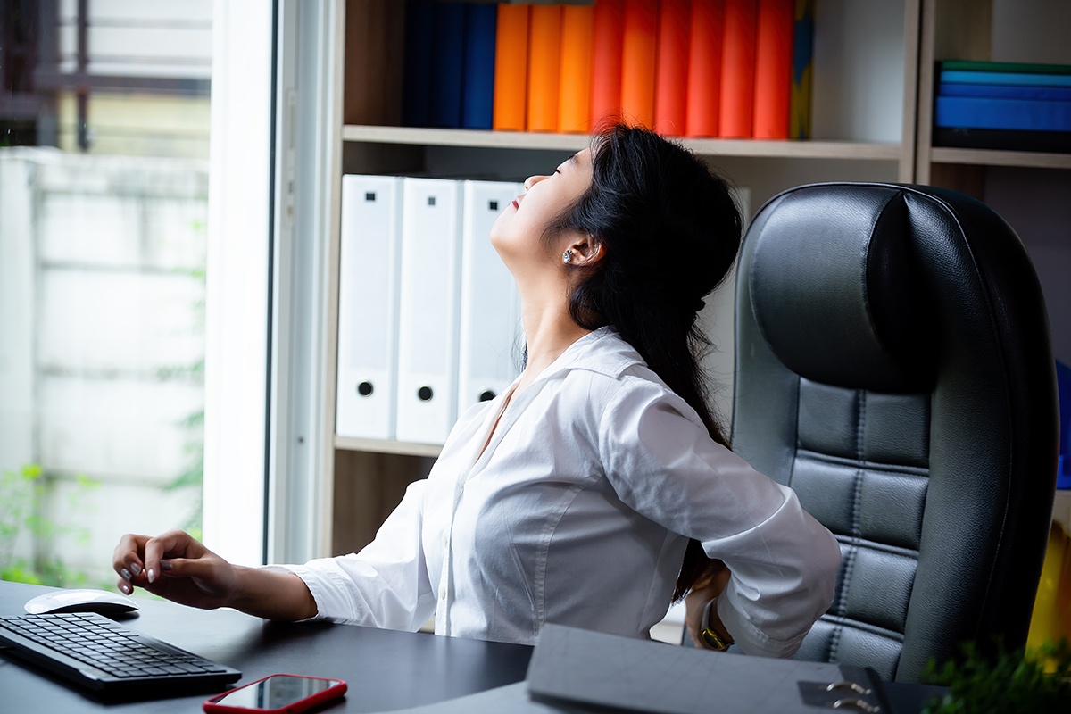 Young working woman back pain while work|lower-back-pain|alleviate lower back pain|back-pain