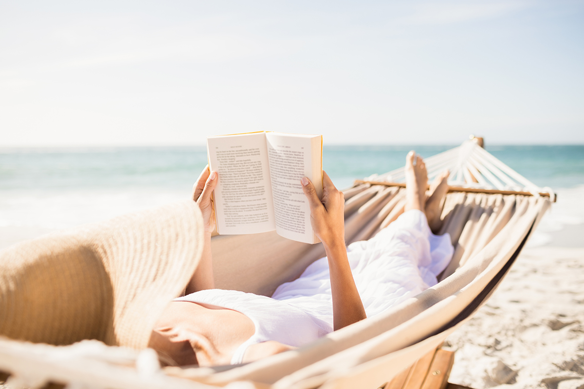 Woman reading book in hammock on the beach|say-no|say-no