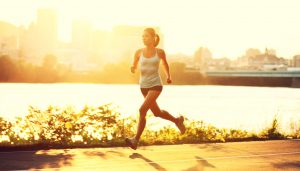 female runner running at sunset in city park. Healthy fitness woman jogging outdoors. Montreal skyline in background.; Shutterstock ID 83732998; PO: The Huffington Post; Job: The Huffington Post; Client: The Huffington Post; Other: The Huffington Post