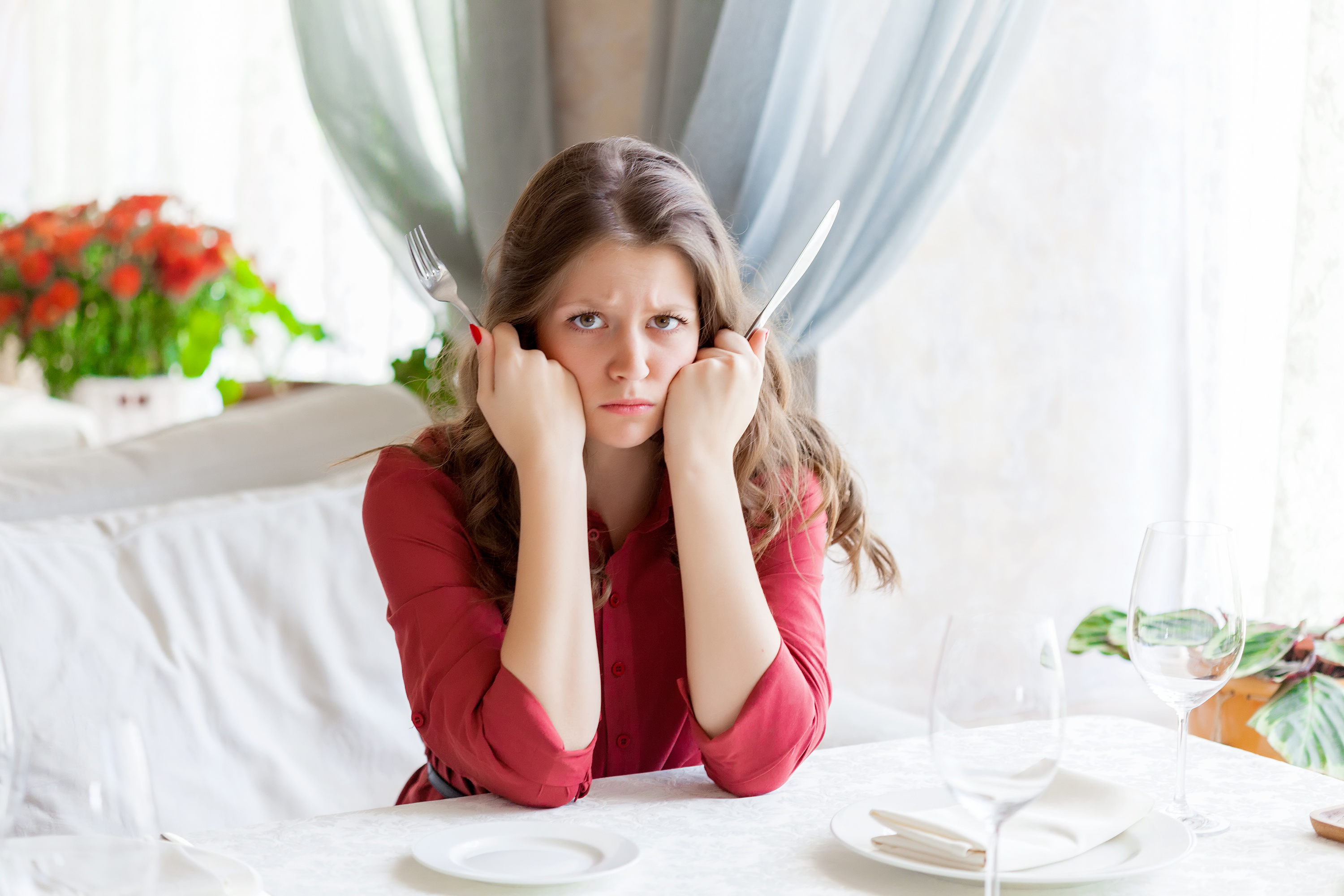 Hungry woman is waiting an order in a restaurant