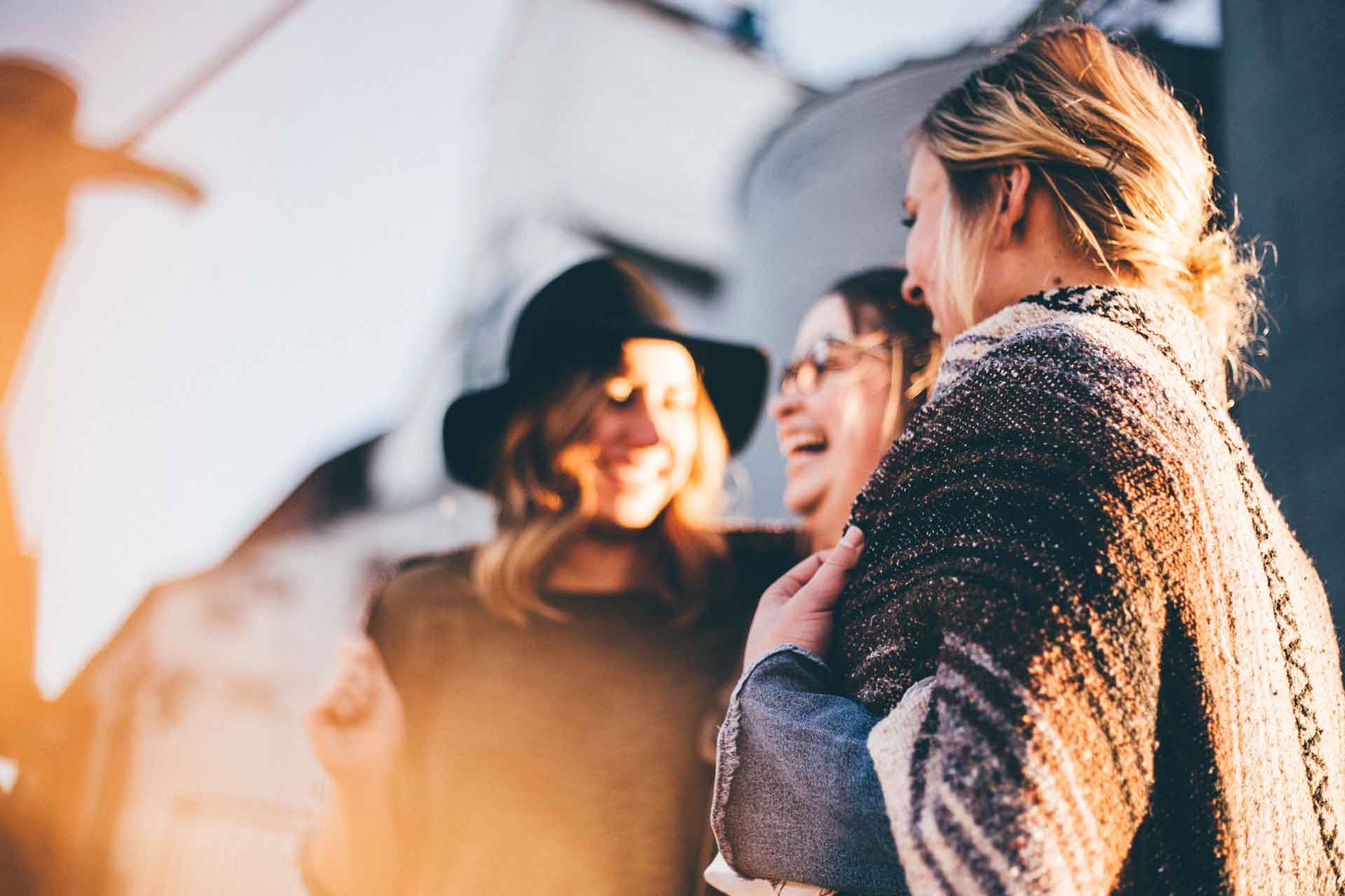 Young women together in a group laughing and talking