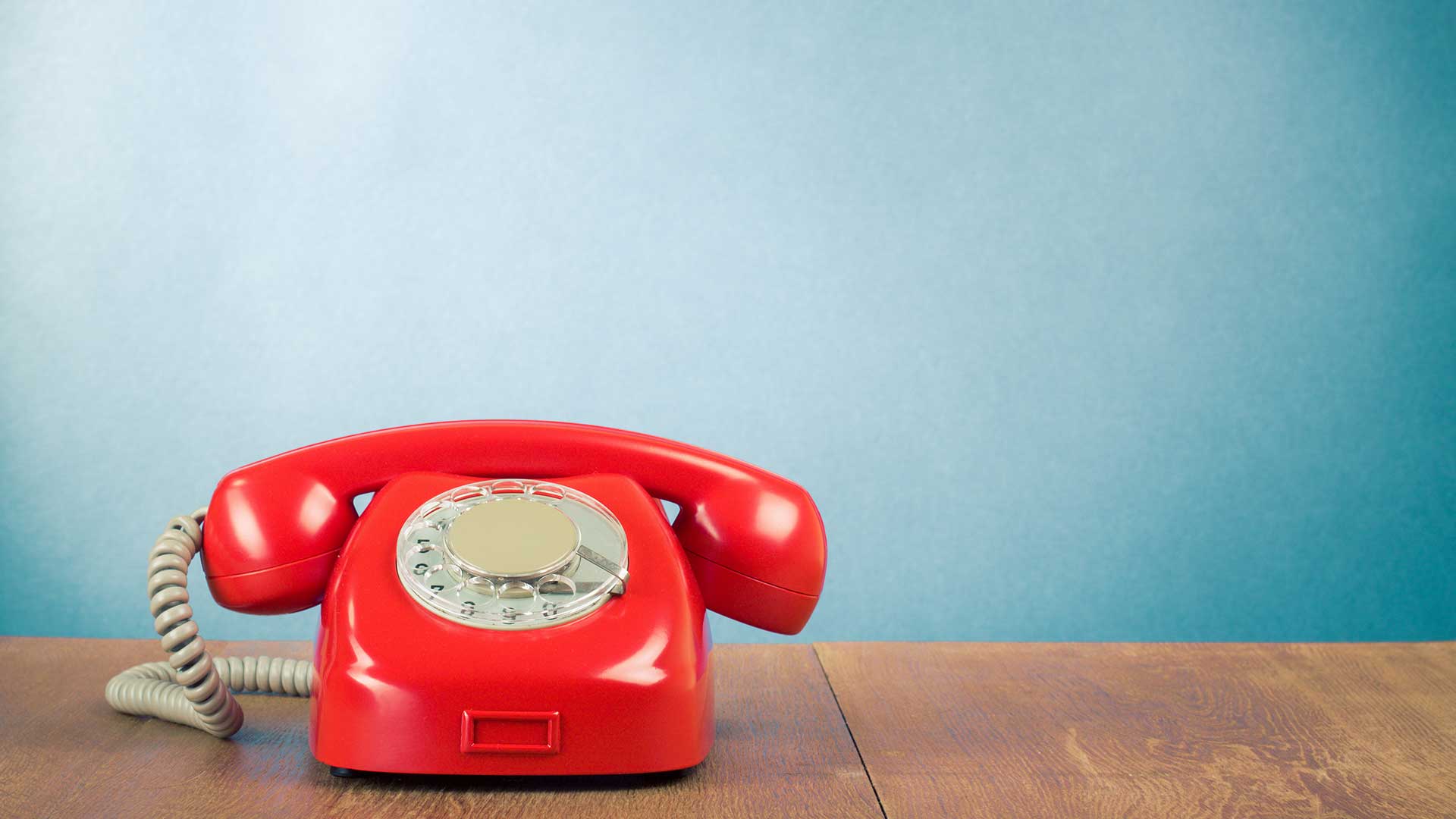 Old dial up red telephone on a table