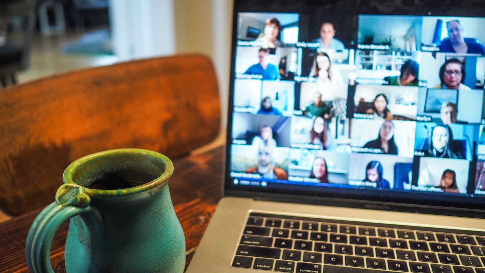 Laptop screen with people in an online meeting