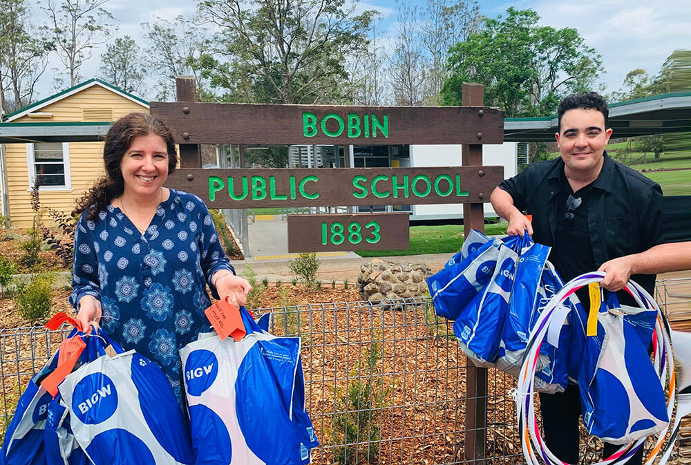 Jason Owen giving gifts at Bobin Primary School 
