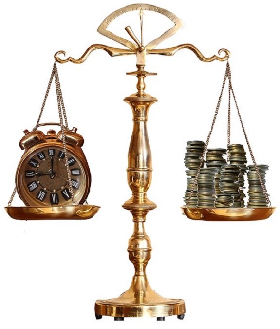 antique brass weighted scale balancing time and money with stacks of coins vs old brass alarm clock.
