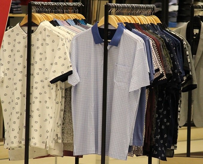 racks of shirts at a clothing store