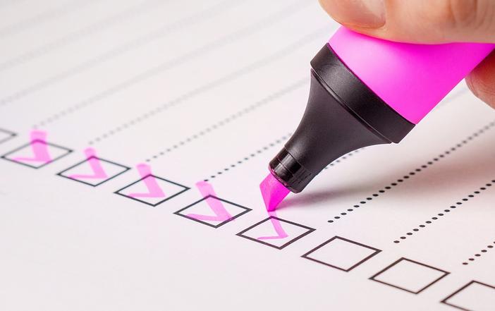 pink highlighter pen checking boxes on a list.