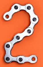 Number 2 formed from bicycle chain links on orange background.