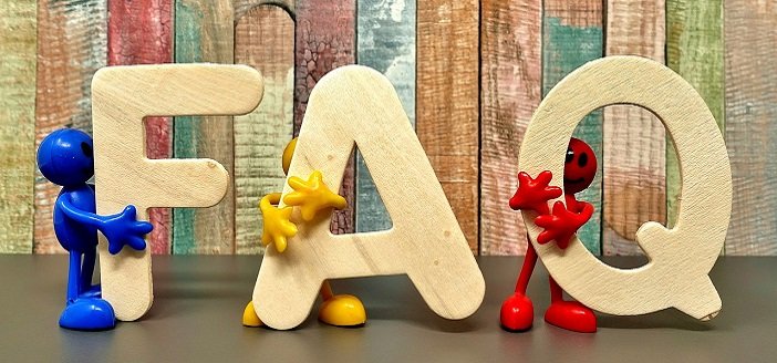 wooden letters spell FAQ held by colorful toy characters