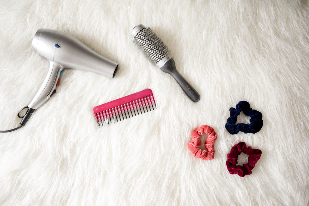 photo of hair dryer comb brush and scrunchy hair bands
