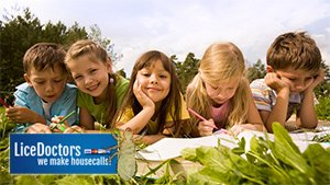 Children studying in the grass - LiceDoctors