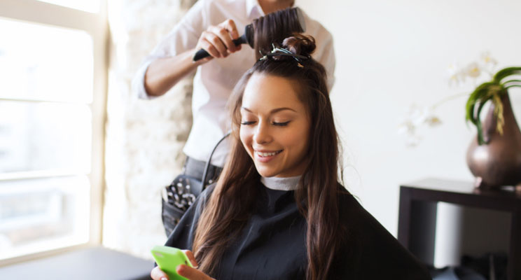 customer in salon on phone pre-booking