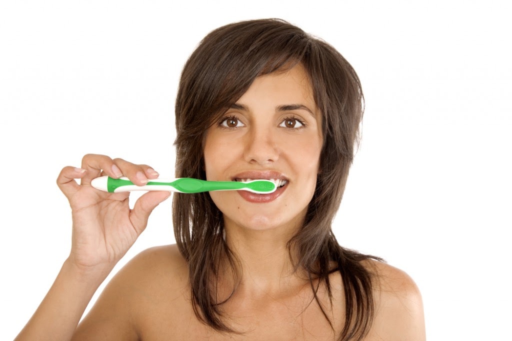 Young woman brushing her teeth