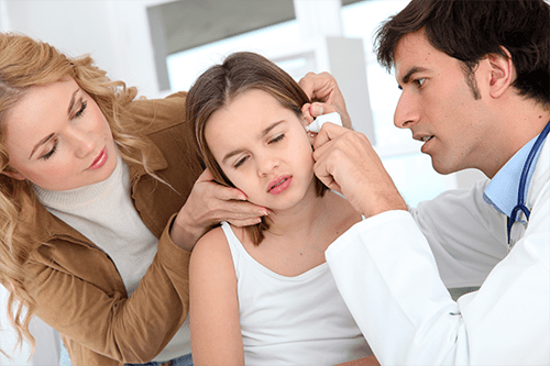 Young girl suffering with ear infections