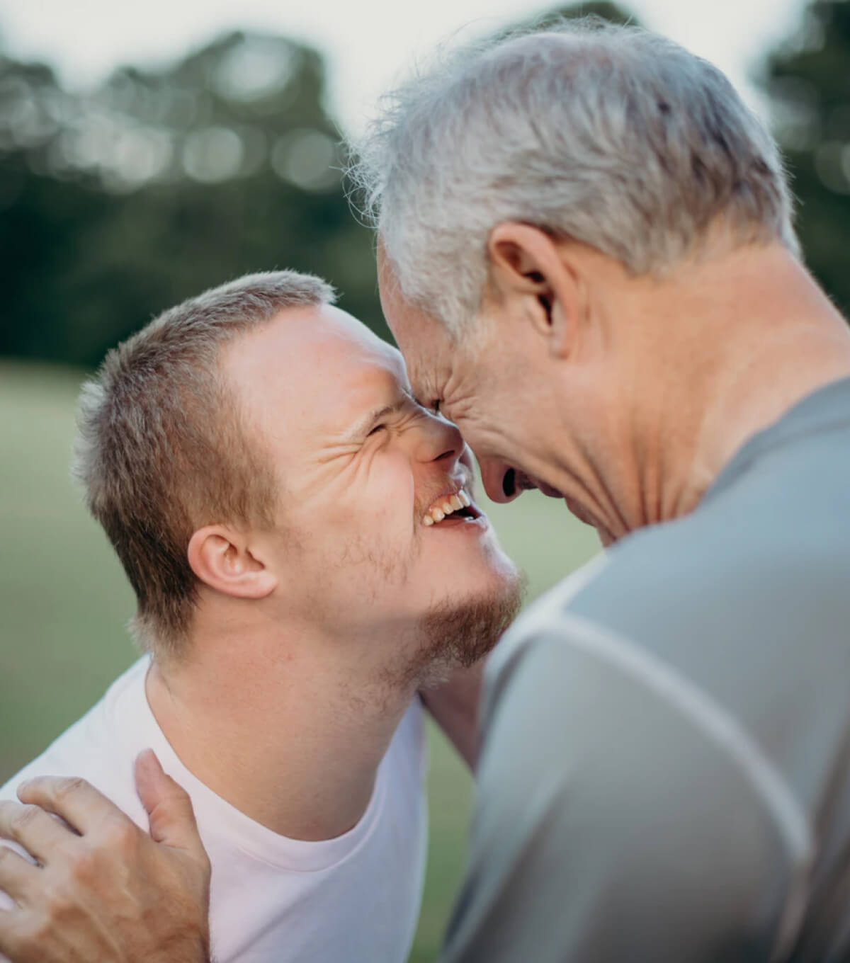 A photo of a boy and father embracing each other